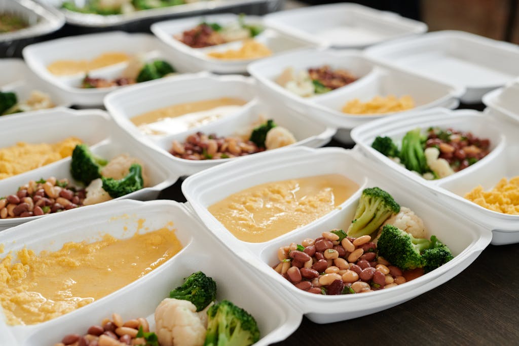 Delicious clean eating meal prep featuring macronutrients, broccoli, beans, and eggs in containers.